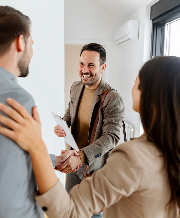 Real estate agent advising clients during a home tour